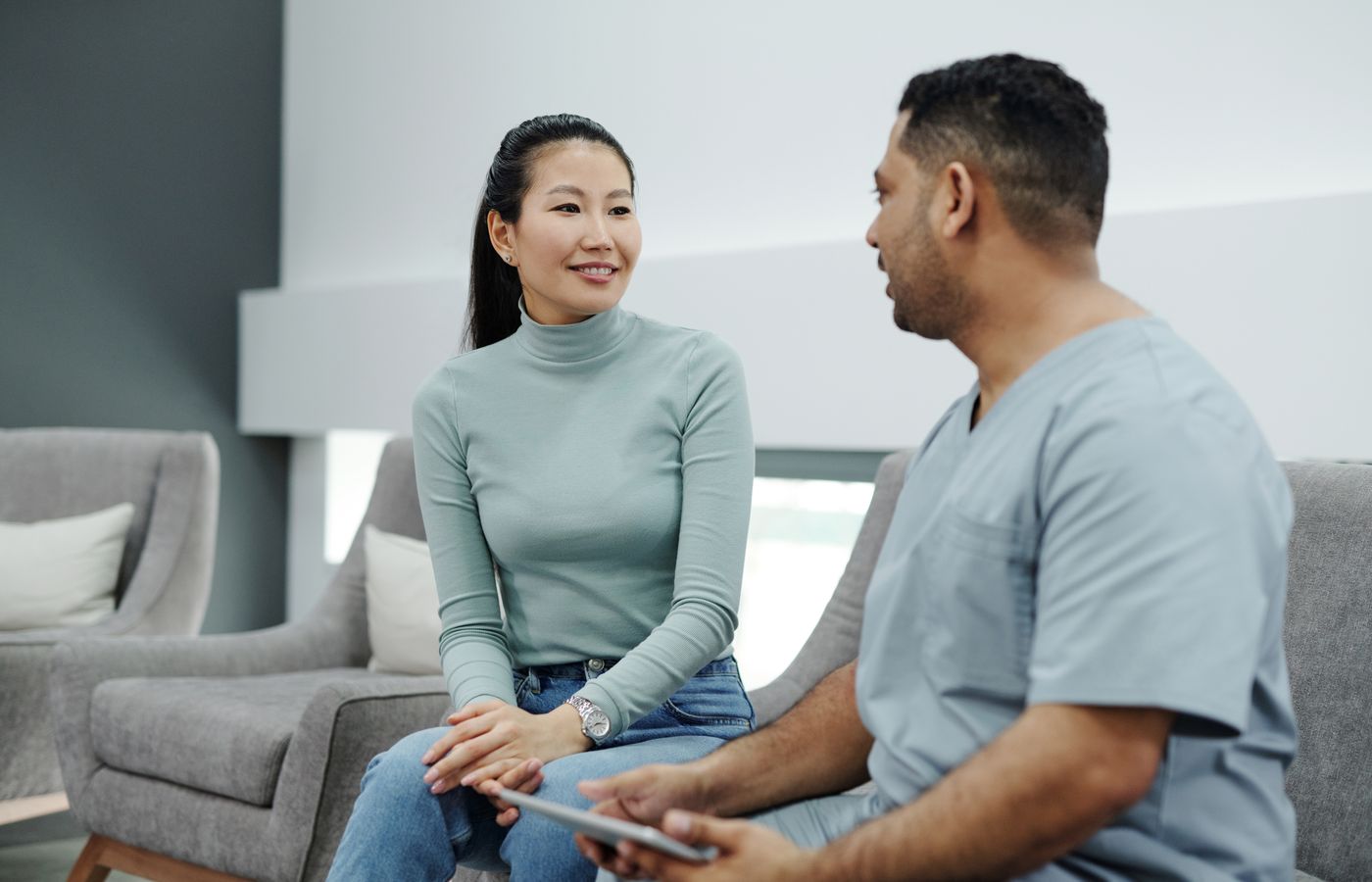 Pain specialist consulting with a patient during diagnostic evaluation